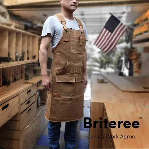 Man wearing waxed canvas woodworking apron with 9 tool pockets in workshop, ideal for DIY projects and builders.
