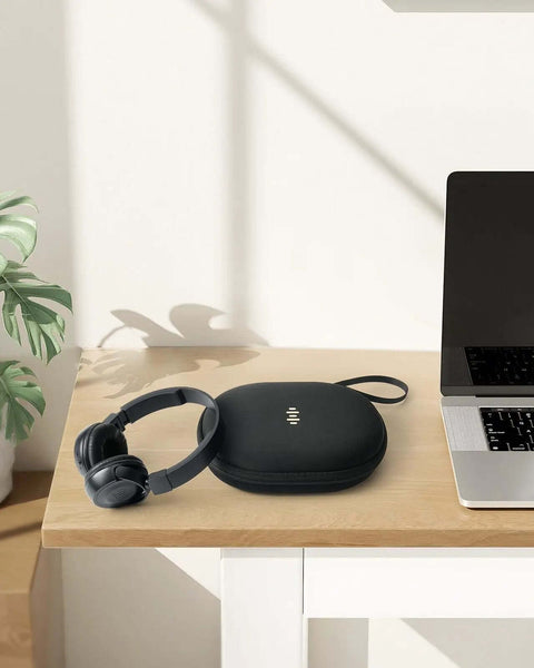 Foldable Hard Shell Over Ear Headphone Case Built Different Hella Tough Travel Organizer Featuring Volume Icon Design on desk with headphones.