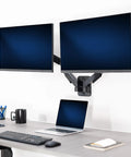 Super Smooth Heavy Duty Double Arm Dual Monitor Wall Mount With Zero Hassle Quick Height Adjustment For Two 17 To 32 Inch Monitors, black finish, two monitors mounted above desk.