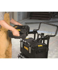 Person placing a ToughSystem unit on a cart with ToughSystem 27 Qt Cooler With 5 Day Ice Retention, Portable Ice Chest For Outdoors.
