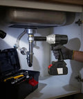 Brace Yourself For The Heavy Lifting With This Badass Brushless Electric Wrench in use under a sink, featuring a 12.7mm anvil.
