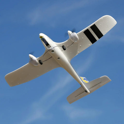 RC Airplane Duet S 2 Ready To Fly Starter Kit With Everything Included flying below a clear blue sky, showcasing black stripes and dual propellers.