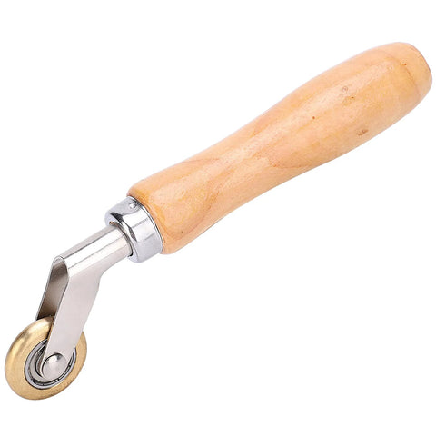 Seam roller with wooden handle and brass wheel for wallpaper and roofing membranes