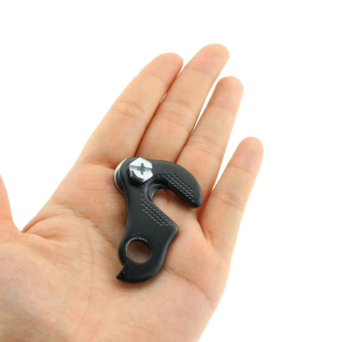 Person holding Two Pack Bicycle Derailleur Hanger Plate For Shimano And SRAM Rear Derailleur Fit Converter Adapter Dropout Black Metal