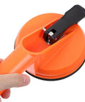 Close-up of Heavy Duty Dual Sucker Window Lifter Tool For Glass And Tile Installation with orange grip and rubber cup pad.