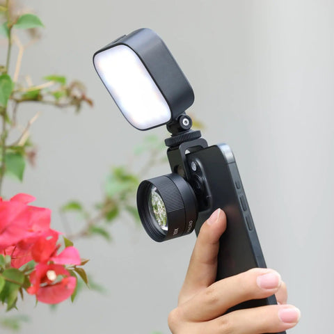 Phone Macro Lens With 10x Optical Magnification And 75mm Focal, 17mm Thread attached to smartphone near flowers