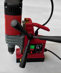 Kickass Portable Magnetic Drill Press Tough As Nails Industrial Grade Workhorse For Heavy Duty Steel And Metal Fabrication With Ac Power Smooth Vertical Action On Job Sites showing controls and handles from a top view.
