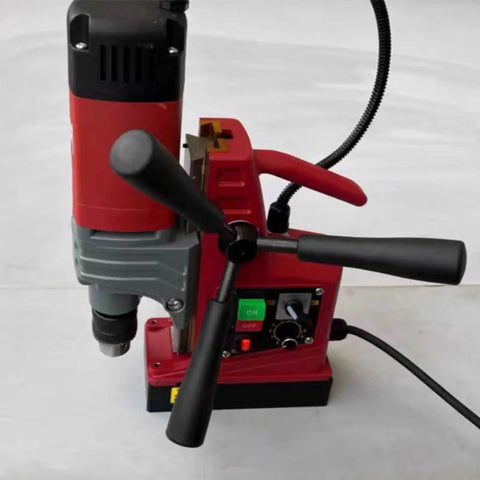 Kickass Portable Magnetic Drill Press Tough As Nails Industrial Grade Workhorse For Heavy Duty Steel And Metal Fabrication With Ac Power Smooth Vertical Action On Job Sites showing controls and handles from a top view.