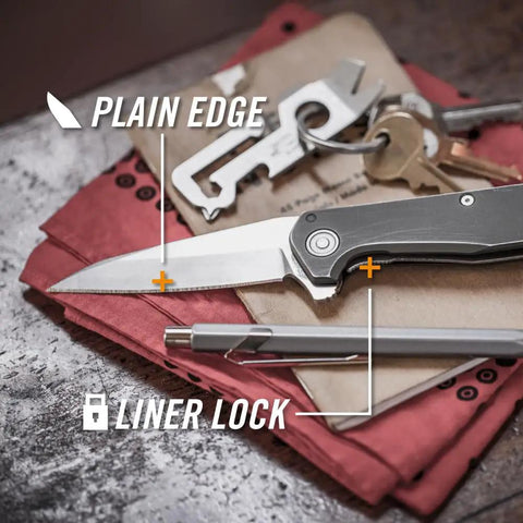 Fastball Slim Folding Knife With Lock Release featuring a 3 Inch S30V Wharncliffe Blade on a desk with keys and tools
