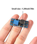 Pack Of 10 Dope MT3608 DC-DC Step Up Boost Converter Modules shown in hand for size comparison, 1.29inx0.70in