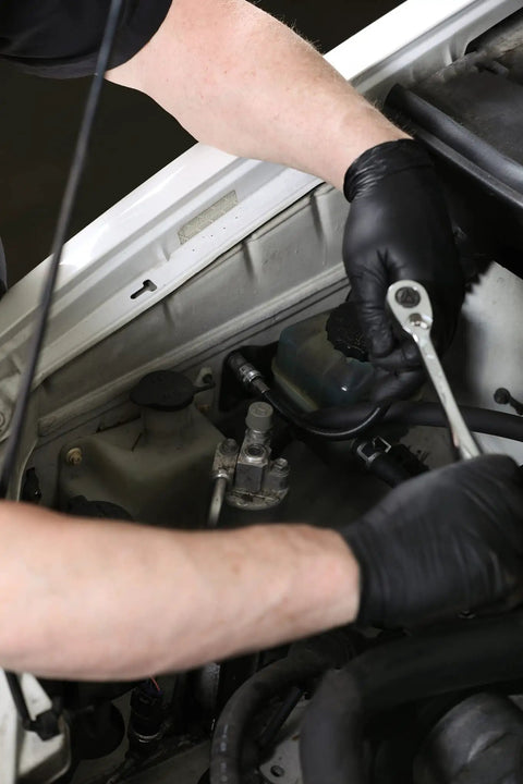 Mechanic using Flexible Socket Extension Set With One Quarter Inch Drive And Three Eighth Inch Drive Extenders Ten Inch And Twelve Inch Lengths Flexible Shafts Spring Loaded Detent Balls Prevent Slipping Ideal For Hard To Reach Bolts And Tight Workspaces in car engine