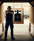 Person aiming at Silhouette Paper Shooting Targets For Range Day Ready 14x22 Inch Red Bullseye Targets For Handgun Pistol Rifle BB And Airsoft