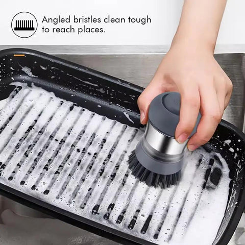 Hand using Stainless Steel Dish Scrubber With Built In Soap Dispenser, Palm Brush For Kitchen Cleaning on soapy grill pan