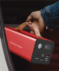 Beast Mode Hella Reliable Portable Power Generator And Charging Station For Outdoor Camping Emergency Backup Battery, compact size, red design, being held.
