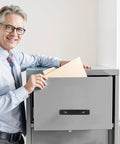 Man using 12 Pack 5.8 Inch Aluminum Alloy Black Cabinet Pull on a grey filing cabinet drawer in office setting.