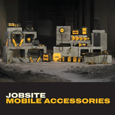 Assorted jobsite mobile accessories displayed on concrete blocks in a dimly lit industrial setting.