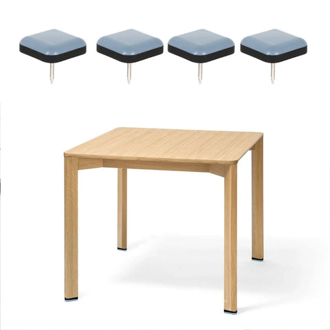 16 Pcs Furniture Glides For Chair Legs With PTFE And Iron Protectors next to a wooden table, easy glide for floors