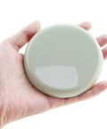8 Pack Heavy Duty Furniture Sliders Reusable Glide Discs For Chair Couch Table Legs holding a glide disc in hand.