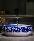 Slick Oval Vessel Sink For Bathroom Vanity Top Notch Premium Porcelain Countertop Wash Basin featuring intricate blue and white hand painted design.