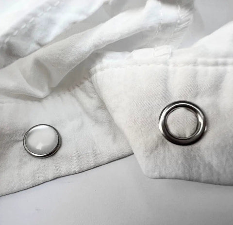 Close-up of 11mm snap fasteners installed on white fabric, part of Snaps With Fastener Pliers Press Tool Kit 40 Set 11mm Snap Fasteners Kit Snap Buttons For DIY Sewing And Crafting Easy To Install With Included Adapters And Pliers Perfect For Clothing Bags Quilting And Home Crafts