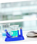 Hands On Newton Pendulum Inertia Demonstrator Kit with beakers, for Classroom Physics Lab Visual Mechanics Tool, on table