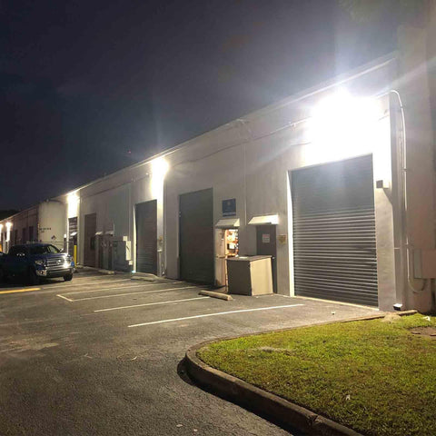 Go-To 120W LED Wall Pack Light With Dusk To Dawn Photocell Glass Lens installed on warehouse exterior for security lighting