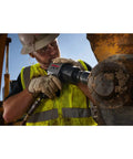 Worker using 3/8-Inch Compact Impact Wrench With Beast Torque Of 500 Ft-Lbs, 10,000 RPM, on heavy machinery