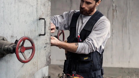 Person wearing Allround Work Tool Vest For Men With Tons Of Pockets, Built Tough Utility Vest With Adjustable Side Fit, Black XXL.