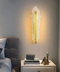 Hella Smooth Game Changing Geometric LED Wall Sconce With Dope Phoenix Tail Design And Acrylic Shade mounted beside bed.