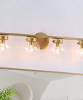 Gold Bathroom Vanity Light 28 Inch Four Light Fixture With Clear Glass Globes, Hand Painted Gold Finish, mounted above mirror