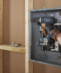 Rock Solid 1/2 Inch Hammer Drill Driver Kit Brushless Motor 565 In-Lbs Torque Core18V Battery in action on electrical panel.