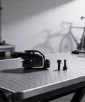 Heavy Duty Mechanical Disc Brakes For Mountain And Road Bikes With Dual Piston Caliper Reinforced Aluminum Frame on worktable with screws.