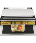 Eighteen Inch No Sweat Hand Cling Film Sealer With Rust Proof Steel Housing And Five Level Adjustable Heat Easy Grip Handle Built Tough For Fresh Fruit Trays Slick Workhorse with assorted fresh fruit in a clear tray.