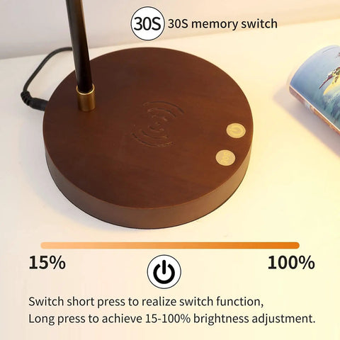Close-up of sleek desk lamp with wireless charging and USB port swing arm brass metal and wood nightstand light base