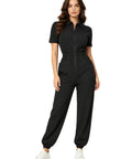 Womens Zipper Front Mechanic Jumpsuit Oil Resistant Scrub Joggers Go To No Sweat Nurse Coveralls Breathable Polyester All Day Grind Workwear In Black Relaxed Fit model wearing black jumpsuit with zip front and elastic waist.