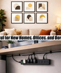 Living room with wall art decor and a workspace underneath featuring a power strip, showcasing the Picture Hanging Tool Kit.