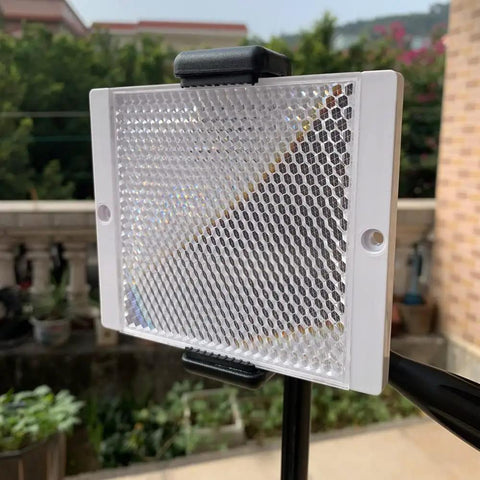 Large 100 By 100 mm Plastic Reflector for Photoelectric Sensors, ideal for infrared and laser applications, installed outdoors on a stand