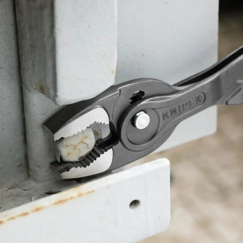 TwinGrip Pliers 10 Inch With Front And Side Gripping Jaws For Stripped Screws gripping a bolt on metal surface