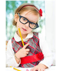 Girl wearing glasses and a plaid dress with a red belt, holding a pencil and wearing a Gold Heart Initial Bracelet For Girls A To Z Stainless Steel Jewelry Perfect Birthday Gift For Kids Ages 6 And Up Cute Flower Girl Accessory For Everyday Wear And Special Occasions.