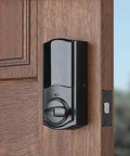 Bluetooth Smart Lock Conversion Kit on wooden door, compatible with Kwikset, Weiser, Baldwin, and Schlage deadbolts.