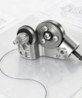 Titanium Drill Nibbler Sheet Metal Cutter Attachment with adapter on a transparent surface showcasing its precise cutting mechanism.