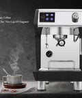 Sleek espresso machine with stainless steel finish next to a steaming cup on a saucer, showcasing modern coffee-making equipment.