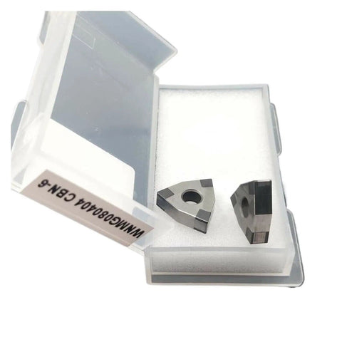 High-Precision Lathe Tool Inserts WNMG080404 CBN-6 And WNMG080408 CBN-6 in a storage box, showing geometric shape and double-edged design.