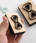Dope Bow Shape Leather Cutting Die Set Two Pack For DIY Leather Projects with wooden frame and Japanese steel blades shown in hand