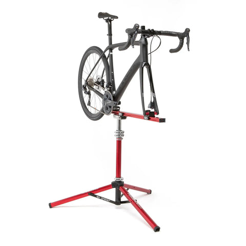 Sprint Bike Repair Stand With Tripod Base And Dropout Style Mount Built To Last Compact Workstand holding a bike