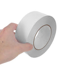No Gimmicks Solid Grip Clear Double Sided Tape For Wall Mounting And DIY Fixes Weather Proof roll held in hand, showing smooth surface.