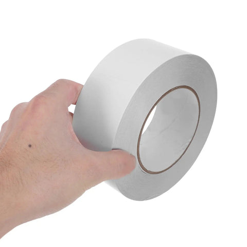Super Smooth Removable Double Sided Tape 5Cm X 164Ft Transparent Pet Roll in hand, showcasing its easy peel design.