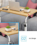 Grab And Go Adjustable Laptop Desk With Smooth Casters Dead Simple Height Tweaks For Living Room Hustle Setup Or Bedside Chill Spot In Modern Matte Black Finish on a sofa with plants and a laptop.