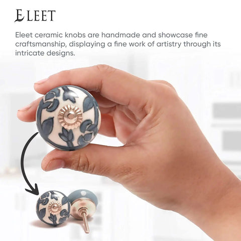 Hand holding a grey and white ceramic cabinet knob with floral design, part of the Assorted Ceramic Cabinet Knobs Set Of 12 In Grey And White With Vintage Old School Charm For Cupboard Doors And Drawers Handmade Look Chrome Hardware Finish Perfect For Kitchen Cabinets And DIY Furniture Renovations.