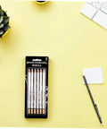 Six Piece White Sketch Pencils Set For Charcoal Drawing Artists And Newbies Soft Medium Hard Graphite For Shading Blending And Texturing Art Supplies Essentials on a yellow desk